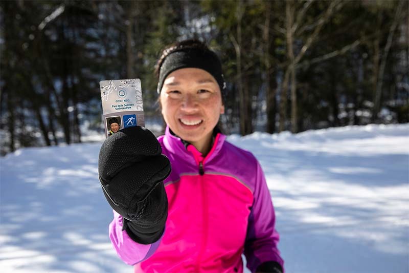 A woman holding up her pass