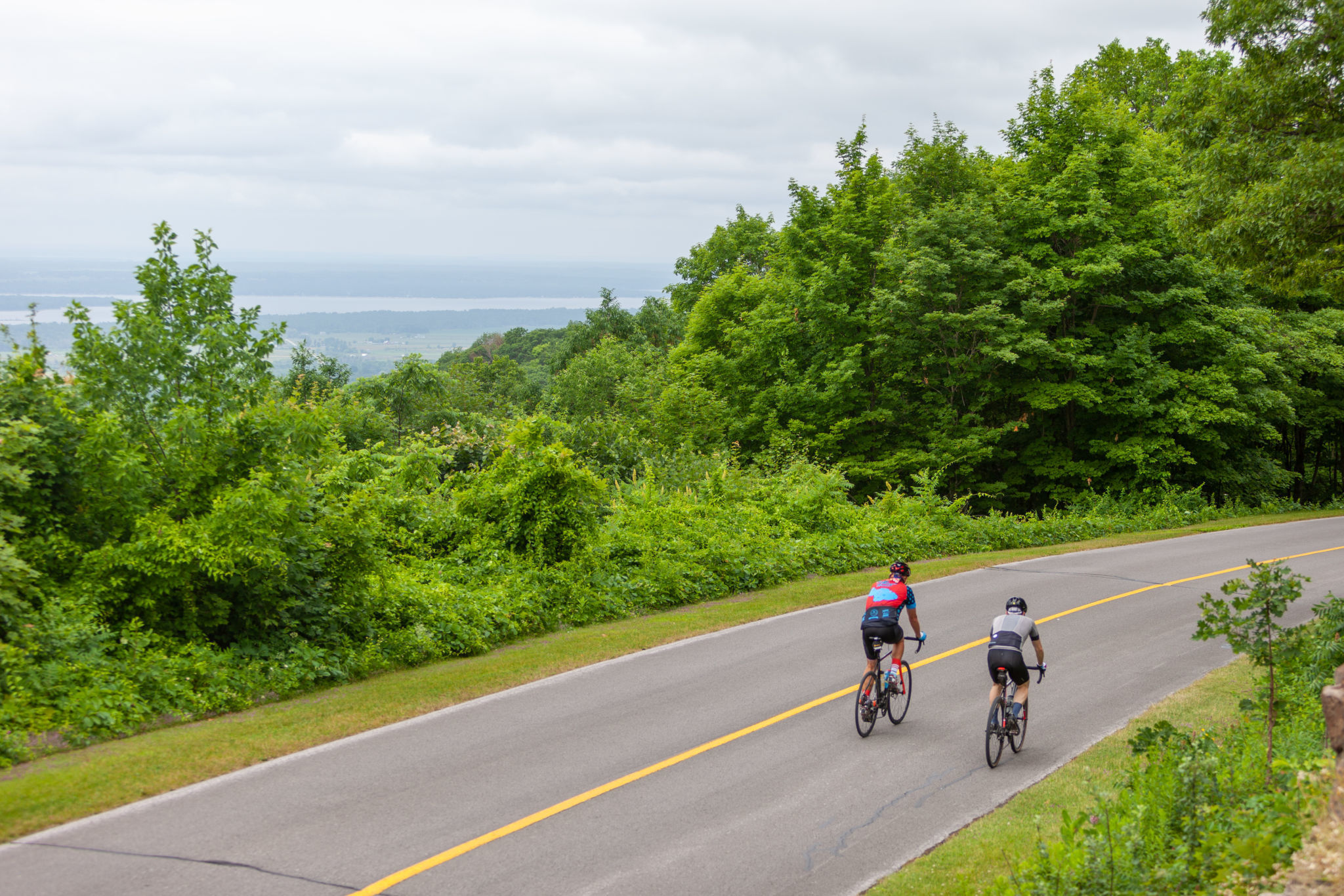 People biking on a the car-free Gatineau Park parkway in Gatineau Park.