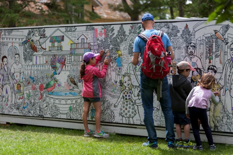 Family drawing on the interactive colouring wall