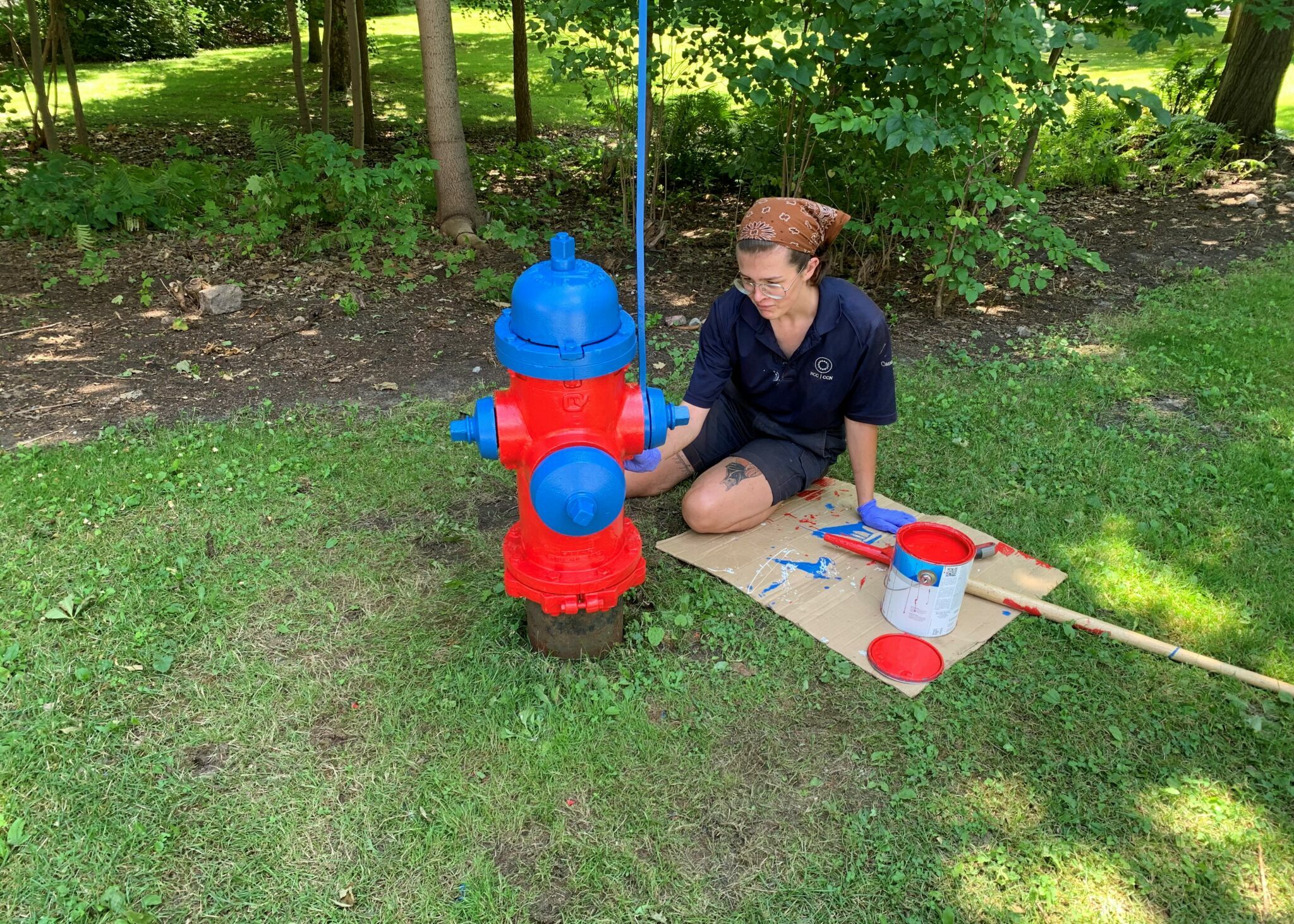 Leo Cox, Rideau Hall grounds student, revitalizing a fire hydrant with paint.