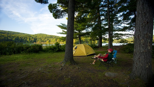 Person sitting on a chair at their campsite in the Taylor Lake sector.