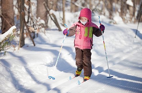 Young skier on classic cross-country tracks