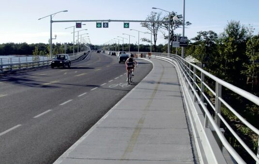 Cars and a cyclist on Champlain Bridge.
